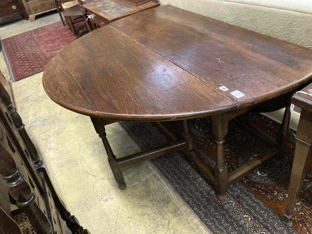 An 18th century oak oval topped gateleg dining table, fitted single drawer, width 130cm depth 50cm height 74cm